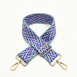 Adjustable blue and purple woven bag strap with V-pattern and gold metal buckles