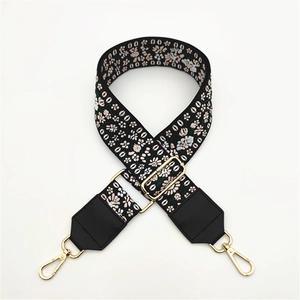 Ethnic embroidered bag strap with colorful floral patterns and gold metal buckles