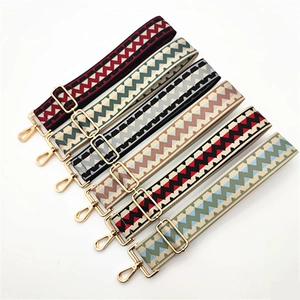 Adjustable wide woven shoulder straps with geometric patterns and gold metal buckles