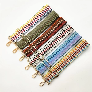 Detail view of 6 colorful woven shoulder straps with light gold metal lobster clasps