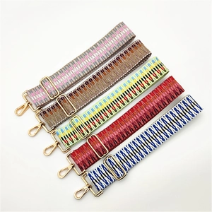 Adjustable wide woven guitar-style shoulder straps with golden metal swivel hooks