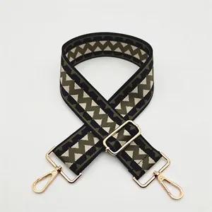 Close-up of adjustable woven shoulder strap with diamond geometric pattern and gold clips