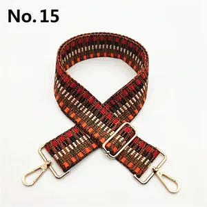 Detail of No. 15 wide geometric woven strap with orange patterns and gold metal buckles