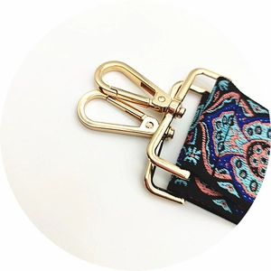 Close-up of ethnic style jacquard bag strap with golden zinc alloy metal swivel hooks