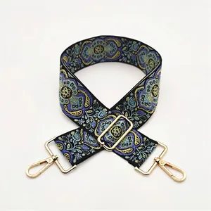 Ethnic style jacquard bag strap with blue floral pattern and gold metal hardware