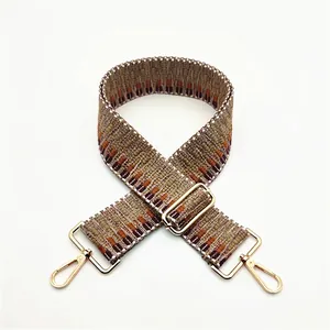 Close-up of geometric woven replacement shoulder strap No. 22 with gold metal buckles