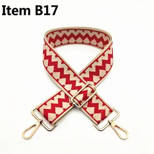 Detail of red and pink zigzag canvas replacement strap with gold metal lobster clasps