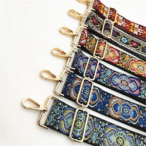 Detail of five bohemian style adjustable shoulder straps with golden metal hooks