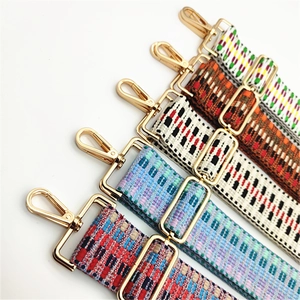 Detail of five ethnic style woven bag straps with gold metal lobster clasps and buckles