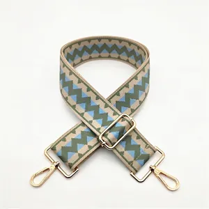 Adjustable geometric wave pattern bag strap in blue and green with gold hooks