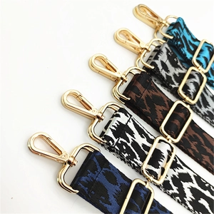 Close-up of leopard pattern bag straps with gold metal lobster clasps and buckles