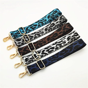 Close-up of five adjustable leopard print bag straps with premium gold metal hardware hooks
