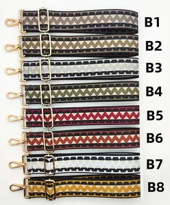 Close-up of colorful replacement handbag straps with wave patterns and gold metal clips