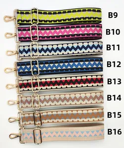 Detail of colorful woven shoulder straps with geometric patterns and gold metal hooks
