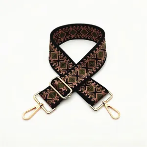 Close-up of diamond pattern bag strap with gold metal swivel hooks and adjustable buckle