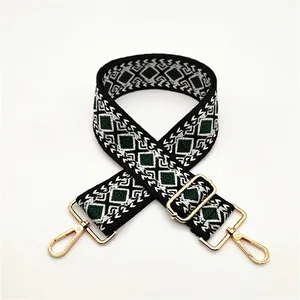Close-up of geometric diamond pattern woven strap with gold metal lobster clasps