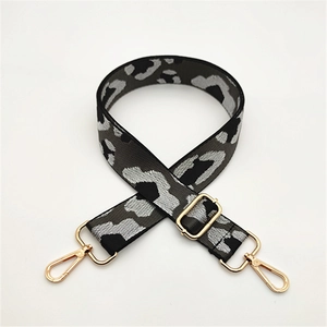 Close-up of leopard print shoulder strap with gold metal lobster clasps and buckles