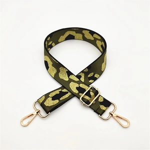 Detail view of army green fabric leopard print shoulder strap with gold metal hardware