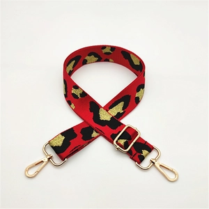 Adjustable leopard print bag strap in red and gold with metallic lobster clasps
