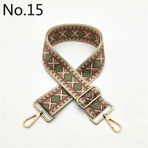 Close-up of geometric diamond embroidery on ethnic style bag strap with gold hooks