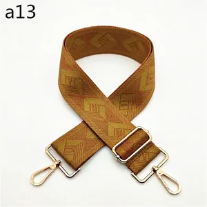 Adjustable brown geometric diamond pattern woven bag strap with light gold metal hardware