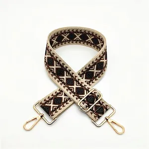 Close-up of bohemian diamond pattern woven strap with gold lobster clasps and metal buckle