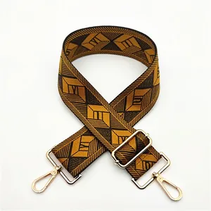 Detail of adjustable woven strap with 3D geometric patterns and gold lobster clasps