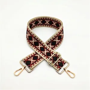 Close-up of Style 18 ethnic woven bag strap with red diamond patterns and gold hardware