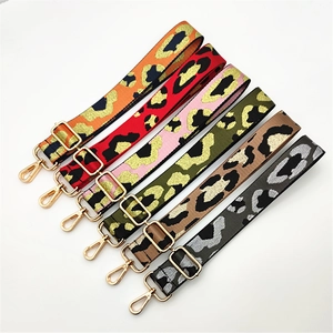 Macro detail of leopard jacquard bag straps with gold metal hooks in various colors