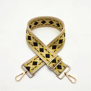 Adjustable wide woven shoulder strap with yellow geometric diamond pattern and gold clips