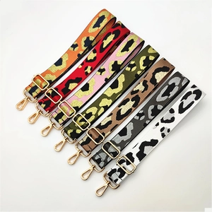 Detailed view of adjustable leopard print bag straps with golden lobster clasps and buckles