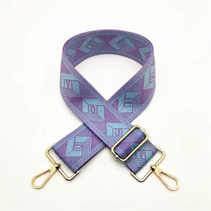 Detail of purple and blue geometric rhombus pattern woven strap with gold metal hooks