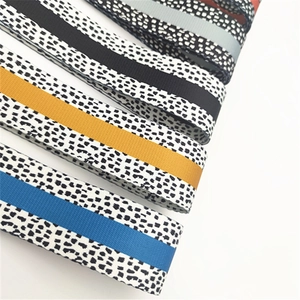 Detailed macro view of high-quality patterned jacquard bag straps in multiple colors