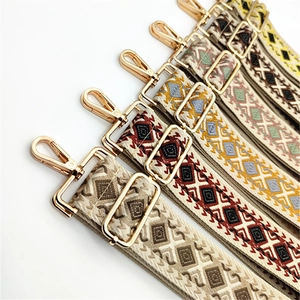 Close-up of diamond pattern bag straps with premium gold metal swivel snap hooks