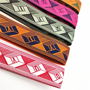 Detail of colorful geometric woven bag straps showing various jacquard patterns and textures