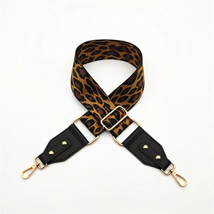 Adjustable leopard print bag strap with black leather ends and gold metal buckles