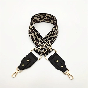 Close-up of leopard print bag strap with golden lobster clasps and adjustable buckle
