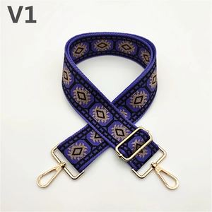 Close-up of ethnic style wide purple strap with geometric patterns and gold metal buckles