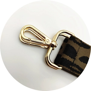 Detail of leopard print bag strap featuring a golden swivel metal hook and dense weave