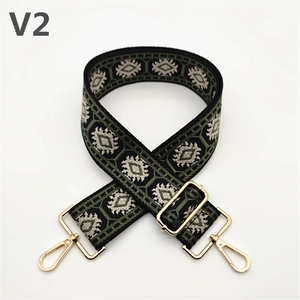 Close-up of ethnic geometric woven strap with golden lobster clasps and adjusters