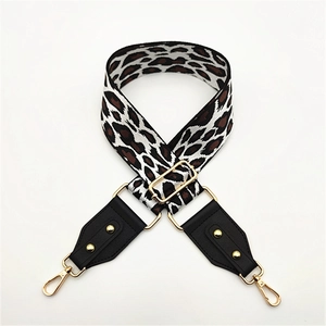 Adjustable leopard print wide canvas shoulder strap with gold hardware on white background
