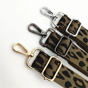 Adjustable leopard print bag strap detail showing gold, black, and silver metal hardware