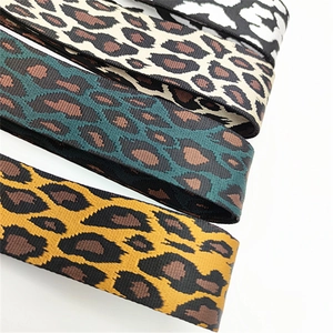 Close-up of four colorful leopard print replacement shoulder straps with woven textures