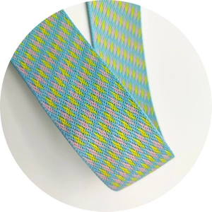 Close-up of geometric woven shoulder strap in light blue, yellow, and purple patterns