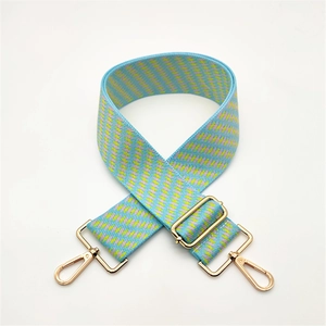 Adjustable wide woven guitar strap for handbags with blue geometric patterns and gold clips