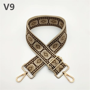 Detail of colorful ethnic jacquard bag strap with golden metal lobster hooks and buckle