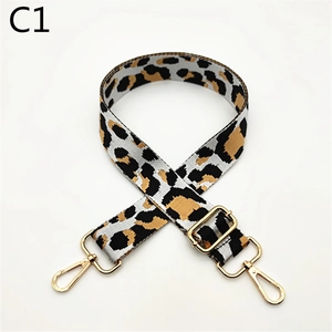 Close-up of leopard print bag strap with golden metal lobster clasps and buckle