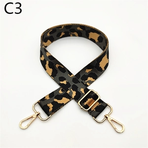 Detail of adjustable leopard print bag strap with golden metal lobster clasps