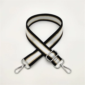 Adjustable black and white woven bag strap with golden trim and metal swivel hooks