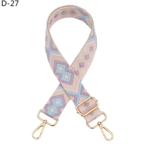 Detail of colorful geometric jacquard bag strap with gold metal lobster clasps